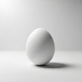A single white egg is positioned upright on a smooth, monochromatic Royalty Free Stock Photo
