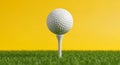 White Golf Ball on a Tee in Front of a Bright Yellow Background sport game Royalty Free Stock Photo