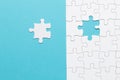 Single white jigsaw puzzle piece blue background . High quality and resolution beautiful photo concept Royalty Free Stock Photo