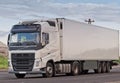 Single white lorry with white trailer over blue sky on the road Royalty Free Stock Photo