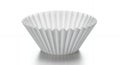 A single white paper coffee filter isolated on a reflective surface Royalty Free Stock Photo