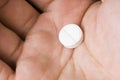 Single white pill in palm Royalty Free Stock Photo