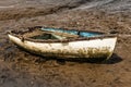 Single white rowing boat stuck on mud flats Royalty Free Stock Photo