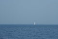 Single white sailboat in blue sea, minimalism