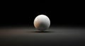 A single white sphere casting a shadow on a dark reflective surface ball round Royalty Free Stock Photo