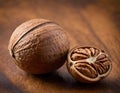 Single Whole Nutmeg Seed with Attached Mace Aril on Rustic Wooden Surface Royalty Free Stock Photo
