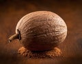 Single Whole Nutmeg Seed with Attached Mace Aril on Rustic Wooden Surface Royalty Free Stock Photo