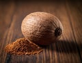 Single Whole Nutmeg Seed with Attached Mace Aril on Rustic Wooden Surface Royalty Free Stock Photo