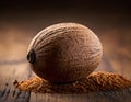 Single Whole Nutmeg Seed with Attached Mace Aril on Rustic Wooden Surface Royalty Free Stock Photo