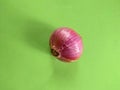 Nutrition:Whole Red Onion Allium cepa Bulb Isolated on Green Background Royalty Free Stock Photo