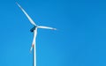 Single wind electricity power turbine against clear blue sky Royalty Free Stock Photo