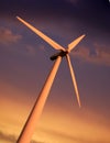 SINGLE WIND TURBINE AGAINST SKY AT SUNSET