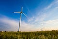 Single wind turbine producing electricity for agricultural area. Summer landscape Royalty Free Stock Photo