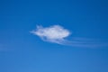 Single wispy white cloud against a deep blue sky. UK Royalty Free Stock Photo