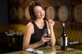 Single woman on a date with wine glass flirting at restaurant winery