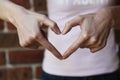 Woman forming heart shape with her hands