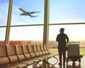 Single woman sitting in airport terminal and passenger plane fly Royalty Free Stock Photo