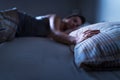 Single woman sleeping alone in bed at home. Lonely lady missing husband or boyfriend. Hand on pillow. Royalty Free Stock Photo