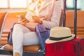 Single woman Travel luggage and ticket waiting for vacation flight in airport