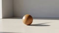 Single wooden ball on lightcolored surface in minimalist setting Royalty Free Stock Photo