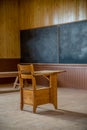 A single wooden desk in an abandoned, one-room schoolhouse on the prairies in Saskatchewan Royalty Free Stock Photo