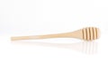 Single wooden for honey spoon on white background, honey stick isolated, Wooden spoon for honey. Close-up Royalty Free Stock Photo