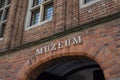 Single word MUZEUM on red brick wall. Sign muzeum on the museum building in Torun, Poland Royalty Free Stock Photo