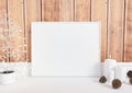 Single 8x10 Horizontal White Frame mockup with christmas decorations on white floor and rustic wooden wall Royalty Free Stock Photo