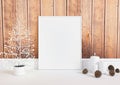 Single 8x10 Vertical White Frame mockup with christmas decorations on white floor and rustic wooden wall Royalty Free Stock Photo