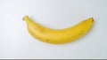 Single yellow banana against white background. Closeup. Royalty Free Stock Photo