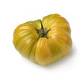 Single yellow coeur de boeuf tomato on white background Royalty Free Stock Photo