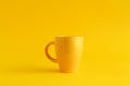 Single yellow coffee cup on yellow background