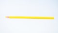 Single yellow colored pencil crayon on a white isolated background Royalty Free Stock Photo