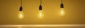 Single yellow lightbulb hangs against vibrant yellow backdrop , single light source, interior Royalty Free Stock Photo