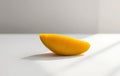 Single Yellow Mango Slice on White Royalty Free Stock Photo