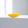 Single Yellow Mango Slice on White Royalty Free Stock Photo
