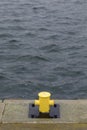 Single yellow mooring bollard