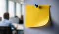 Single yellow post-it note attached to wall with push pin Royalty Free Stock Photo