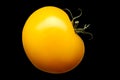 Single yellow tomato isolated on black background Royalty Free Stock Photo