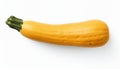 Single yellow zucchini with a green stem on white background