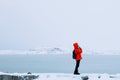 Single young woman standing by Arctic ocean