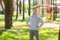 Single young man doing exercises in the forest park, street workout. Fitness outside. Exercising alone for Covid-19 revention