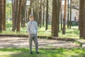 Single young man standing in the park before training, street workout. Fitness outside