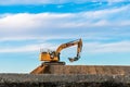 Cat yellow heavy machinery excavator digger on a road construction site