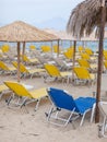 Singular blue deck chair among many yellow