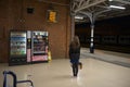 Singular young woman waits during the night at doncaster train station