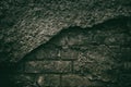 Sinister eerie background of dark old brick wall with fallen off Royalty Free Stock Photo