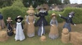 A sinister scarecrow festival with straw figures everywhere