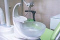 Sink at a dental office. Tools in a dentists office close up background and the chair. Medical equipment and stomatology concept.