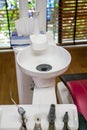 Sink at a dental office. Tools in a dentists office close up background and the chair